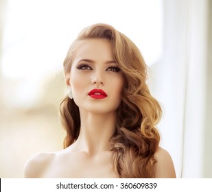 Beautiful fashion model Woman with hair, Red lipstick . Portrait of glamour girl with bright makeup. Beauty female face close up with perfect make up