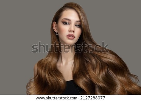 Beautiful fashion woman long curly big curls. Hair and makeup