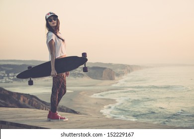 Beautiful and fashion young woman posing with a skateboard - Powered by Shutterstock