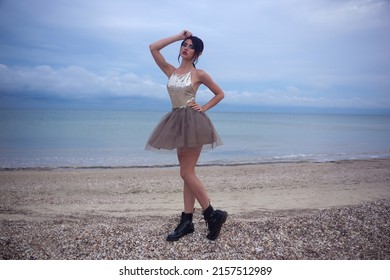 Beautiful Fashionable Girl Stands On The Seashore Of The Sia In A Chiffon Skirt And A Shiny  Shirt At The Watter