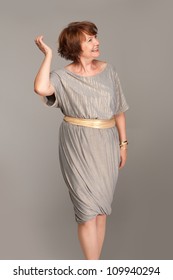 Beautiful Fashionable Mature Woman In Grey Dress. Studio Shot.