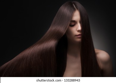 Beautiful Fashionable Woman With Long Hair On Dark Background