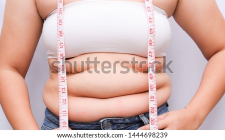 Beautiful fat woman with tape measure She uses her hand to squeeze the excess fat that is isolated on a white background. She wants to lose weight, the concept of surgery and break down fat under the 