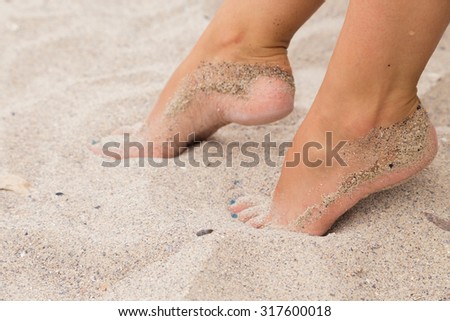 Beautiful feet in the sand. Sea, sand, rest, macro.