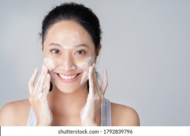 Beautiful Female Asian Wash Face  In Studio