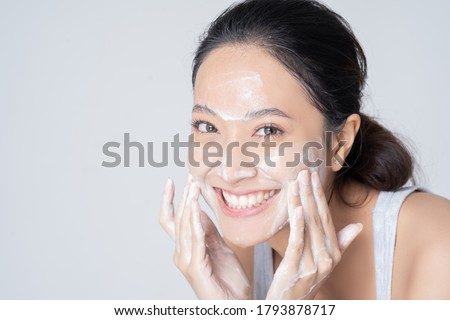 Beautiful female asian Wash face in studio
