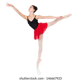 Beautiful Female Ballet Dancer Isolated On A White Background. Ballerina Is Wearing A Black Leotard, Pink Stockings, Pointe Shoes And A Red Dress.