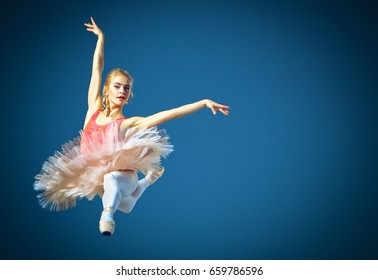 Beautiful female ballet dancer on a grey background. Ballerina is wearing pink tutu and pointe shoes. - Powered by Shutterstock