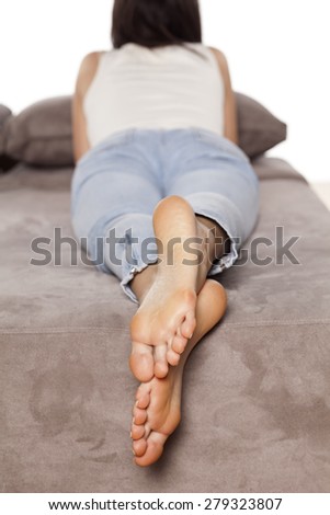 Beautiful female bare feet of a woman who lies and rests