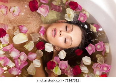 Beautiful female in bath with rose petal. Body care. - Powered by Shutterstock