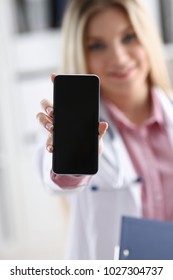 Beautiful Female Blonde Doctor Holding Smartphone