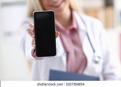 Beautiful Female Blonde Doctor Holding Smartphone