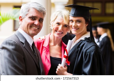 Beautiful Female College Graduate With Parents On Graduation Day