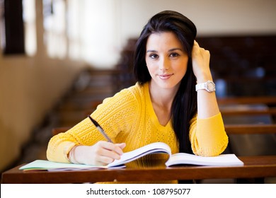 Beautiful Female College Student Sitting In Classroom