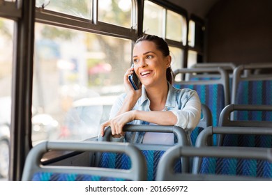 Beautiful Female Commuter Talking On Cell Phone While Taking Bus To Work