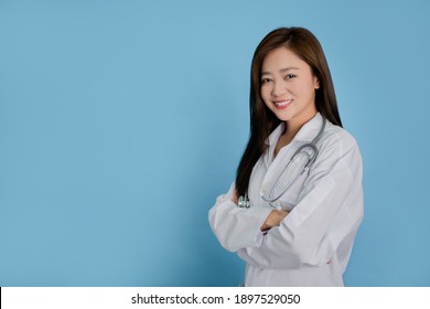 Beautiful female doctor isolated on blue background.