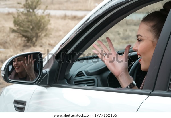Beautiful female driver driving a car.\
Young woman driver angry gesturing to other\
drivers