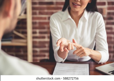 Beautiful female employer in suit is conducting a job interview while sitting in her office - Shutterstock ID 588272756