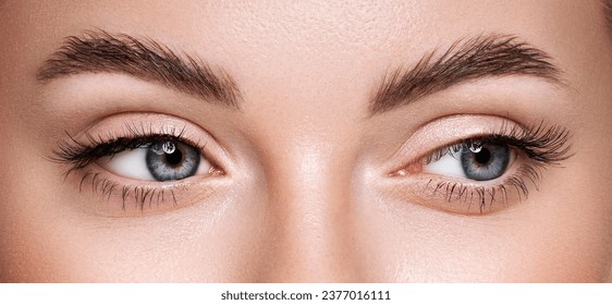 Beautiful female eyes with long eyelashes. Eyelash extensions. Makeup, cosmetics, beauty. Close up, macro