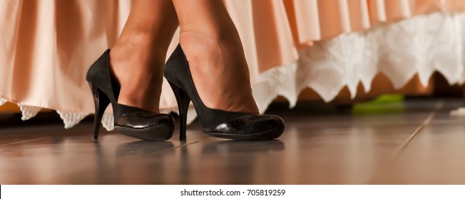 Beautiful female feet close-up and black shoes on them - Shutterstock ID 705819259