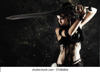 Beautiful female fighter with a sword in her hands.