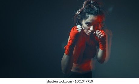 Beautiful Female Fighter Trains In Boxing Bandages In Studio On Gray Background. Women's Mixed Martial Arts Poster