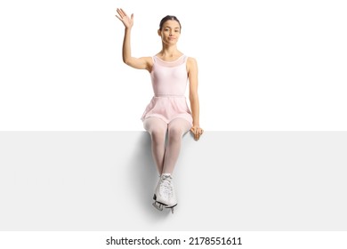 Beautiful Female Figure Skater Sitting On A Blank Panel And Waving Isolated On White Background