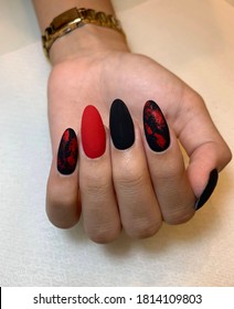 beautiful female hand and long nails matte black   red manicure