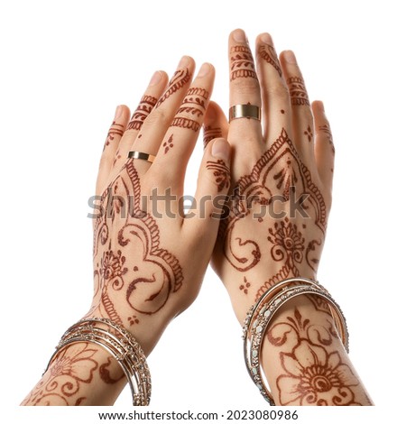 Beautiful female hands with henna tattoo on white background