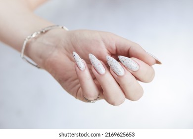 Beautiful Female Hands With Long Nails Light White Manicure And A Bottle Of Nail Polish