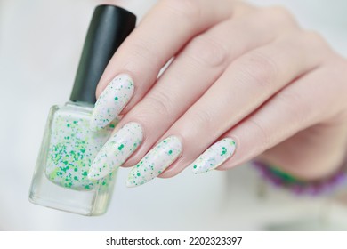 Beautiful Female Hands With Long Nails Light White Manicure And A Bottle Of Nail Polish