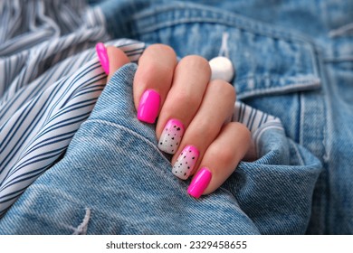 Beautiful female hands with a manicure on a denim background. Shaded nail design. Summer manicure. Copy space.