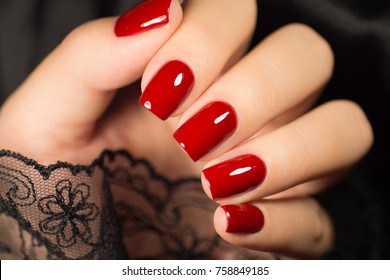 Beautiful female hands with red manicure