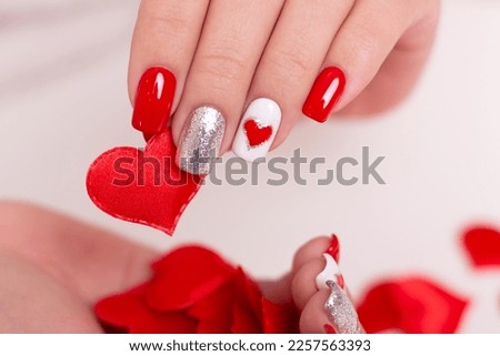 Beautiful female hands with red manicure nails, hearts design, on white background
 Stock foto © 