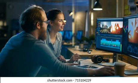 Beautiful Female and Handsome Male Video Editors Discuss Footage They're Working On. They Enjoy Working Together in a Cozy Creative Studio. - Shutterstock ID 715104229