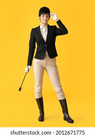 Beautiful Female Jockey On Color Background