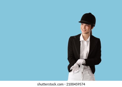 Beautiful Female Jockey On Color Background