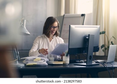 Beautiful female journalist and professional employee and editor working on an exciting assignment at her office desk, looking happy and smiling about the interesting job.  - Shutterstock ID 2138297583
