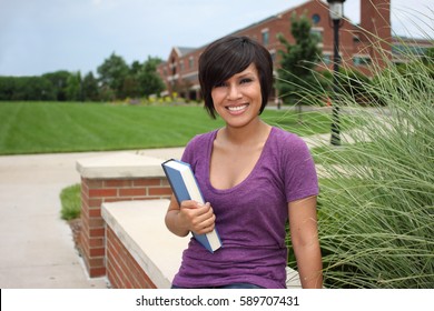 A Beautiful Female Latino Student On A University Campus.