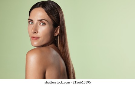 Beautiful female model, 40s years old, has perfect shiny, glowing body, facial skin, nourished and hydrated face after spa, cosmetic procedure, green background - Shutterstock ID 2156613395