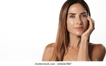 Beautiful female model, 40s years old, has perfect shiny, glowing body, facial skin, nourished and hydrated face after spa, cosmetic procedure, white background.