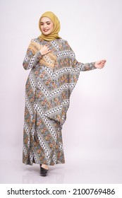 Beautiful female model wearing modern batik kebaya with hijab, an Asian traditional dress for Muslim woman isolated over white background. Stylish Muslim female fashion lifestyle  concept.