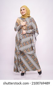 Beautiful female model wearing modern batik kebaya with hijab, an Asian traditional dress for Muslim woman isolated over white background. Stylish Muslim female fashion lifestyle  concept.