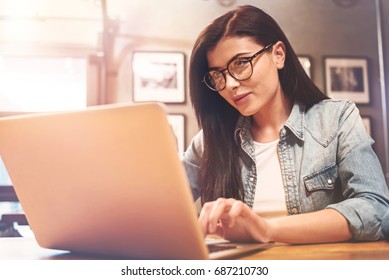 Beautiful Female Person Looking At Screen Of Her Laptop