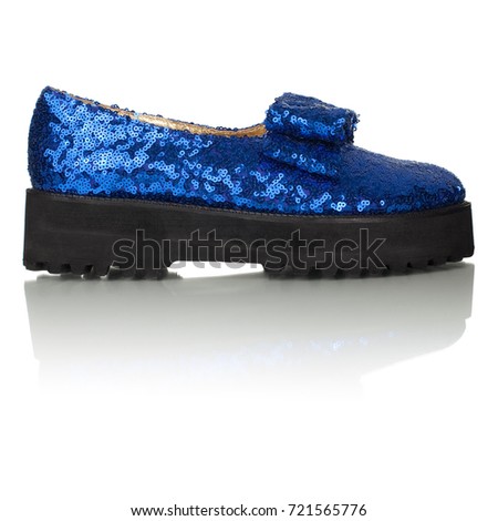 Beautiful female shiny luxury blue shoe on a thick sole on a white background, side view