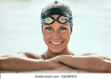 Beautiful Female Swimmer on pool edge - Powered by Shutterstock