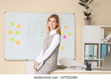 Beautiful female teacher in classroom - Shutterstock ID 1479223385