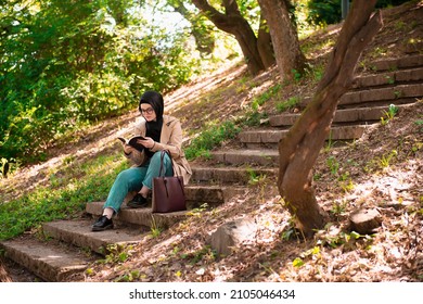 Beautiful Female Teen Reading Poetry In A Park