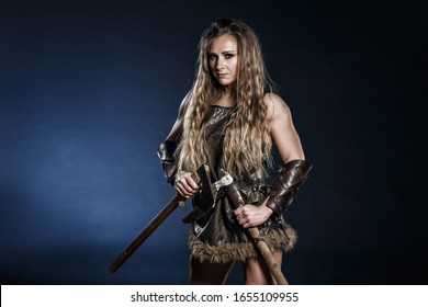 Beautiful Female Viking Woman Warrior With Battle Axes. Ancient Times. Amazon Fantasy Blonde Hair Sexy Girl.