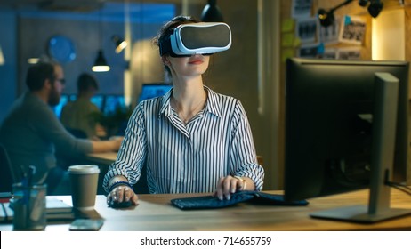 Beautiful Female Virtual Reality Engineer/ Developer Wearing VR Headset Creates Content. She Works in a Creative Designers Studio.